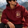 Mountain Is Calling Hoodie — Maroon — worn on a mountain trail The Mountain Is Calling hoodie in Maroon — worn on a mountain trail