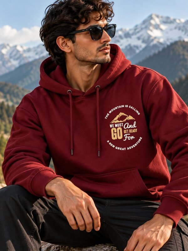The Mountain Is Calling hoodie in Maroon — worn on a mountain trail
