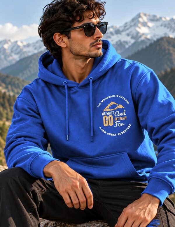 Mountain Is Calling Hoodie — Royal Blue — worn on a mountain trail The Mountain Is Calling hoodie in Royal Blue — worn on a mountain trail
